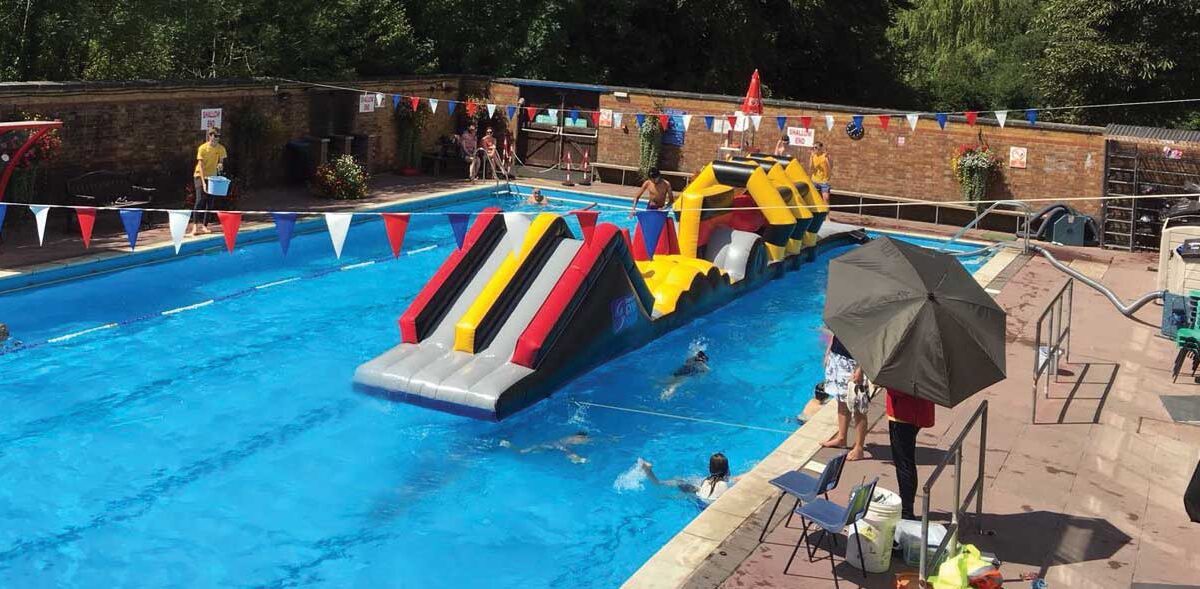 Children enjoying an inflatable swim session