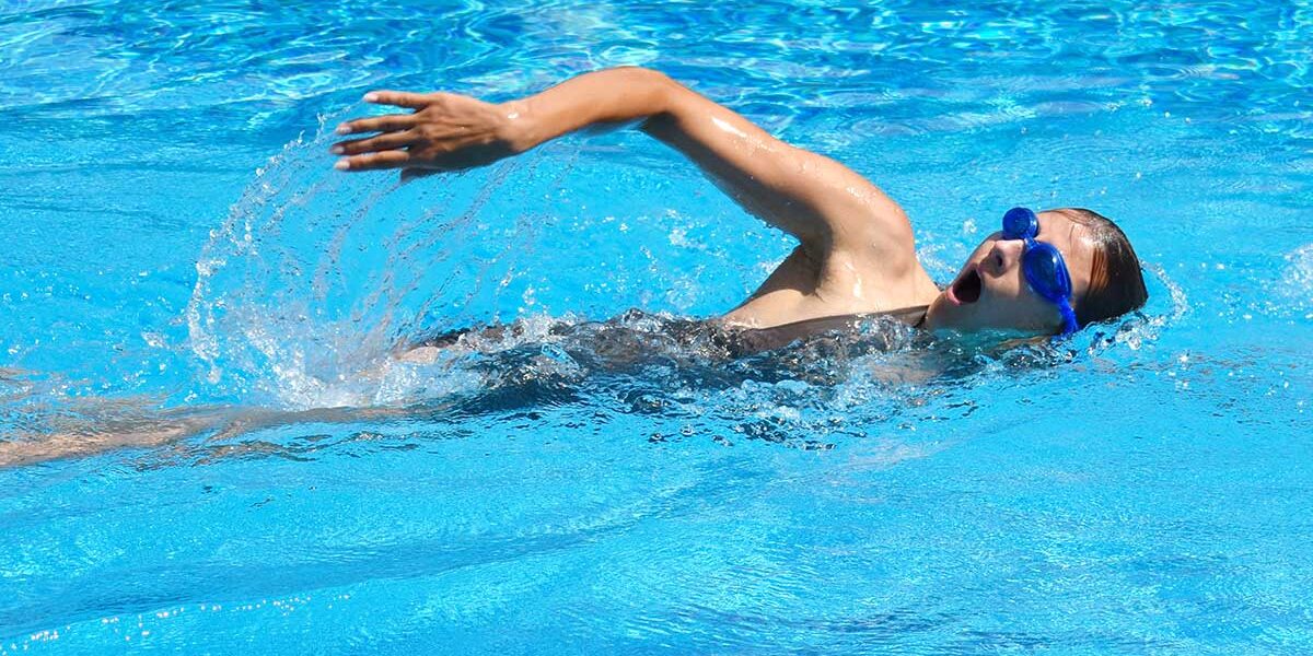 Young adult swimmer doing front crawl