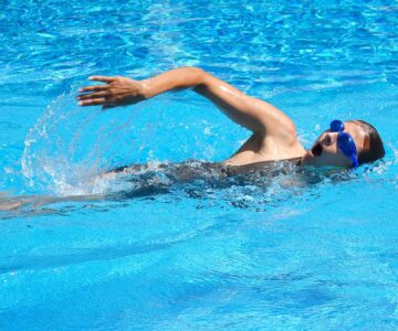 Young adult swimmer doing front crawl