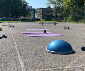 outdoor court with circuits equipment laid out – dome, mats and weights