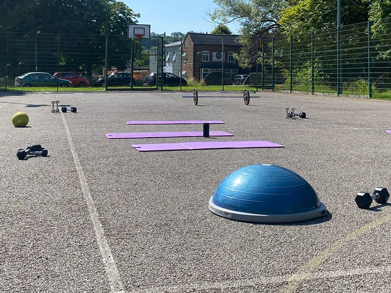 outdoor court with circuits equipment laid out – dome, mats and weights