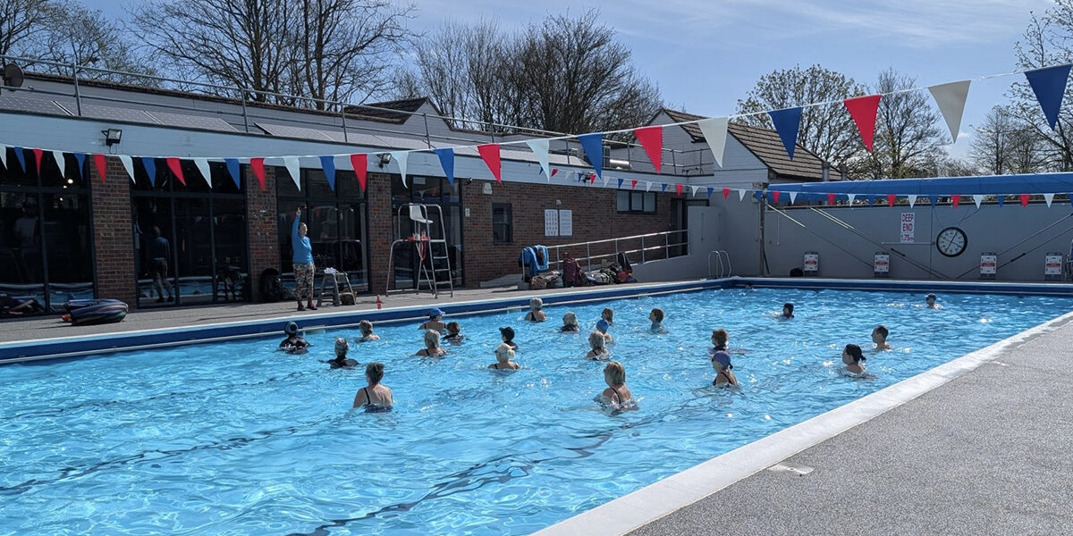 aqua/water aerobics class on a sunny dayin outdoor pool